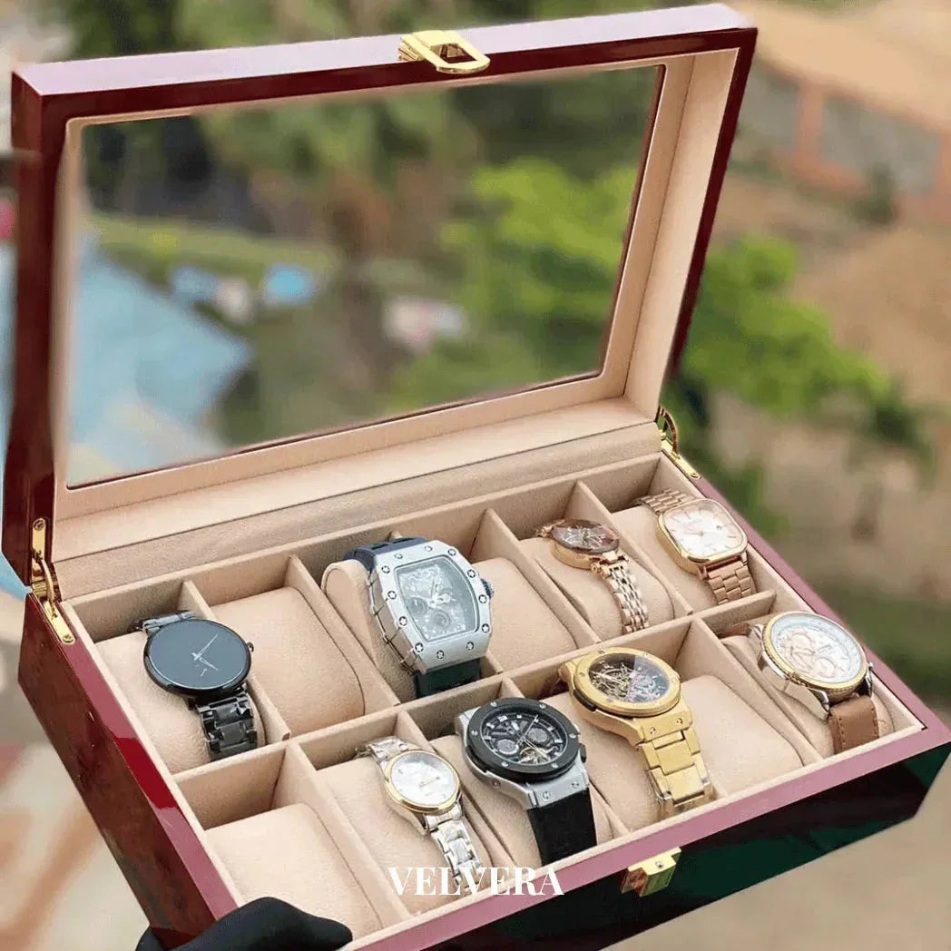 Luxury watch display box with assorted men's watches, glass lid, beige interior, Velyera logo