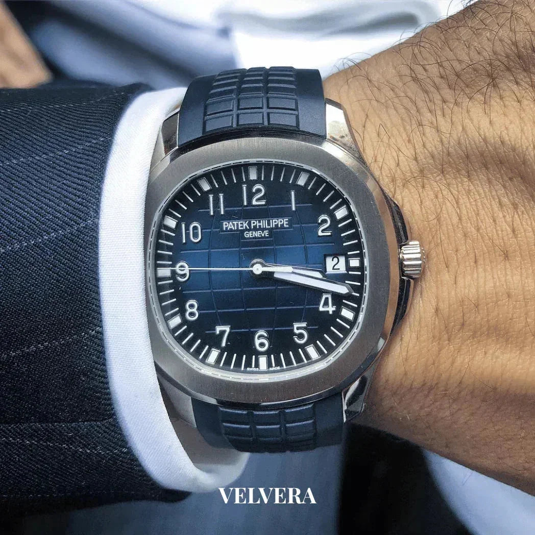 Blue Patek Philippe Aquanaut watch with rubber strap on wrist, formal suit sleeve, Velvera