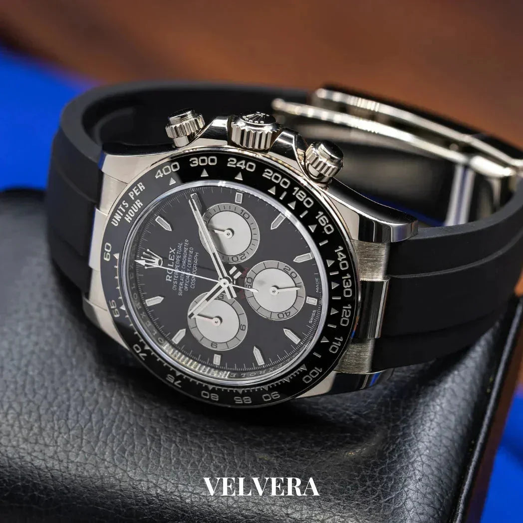 Luxury Rolex Daytona watch with black dial and rubber strap on leather case, Velvera branding