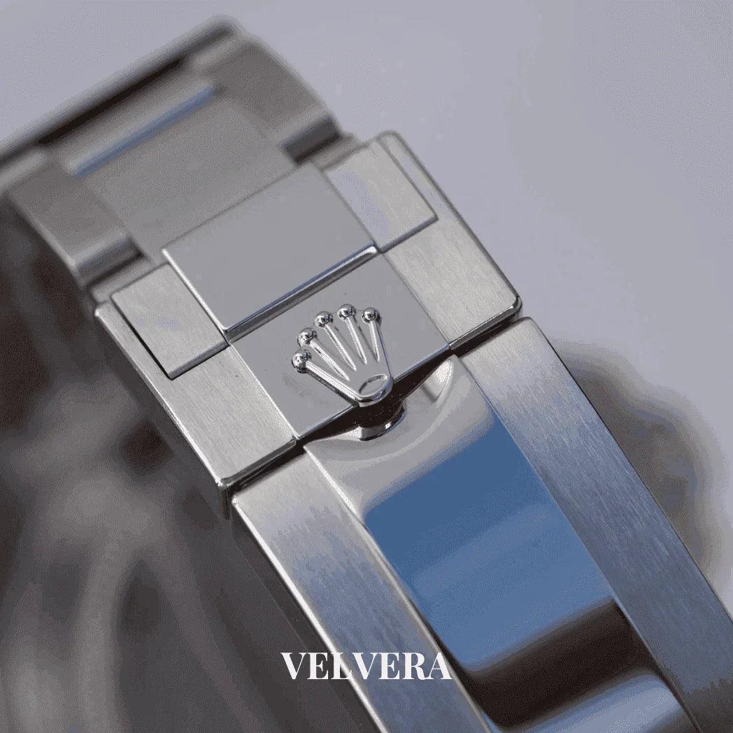 Close-up of a stainless steel Rolex watch clasp with crown logo and Velvera branding