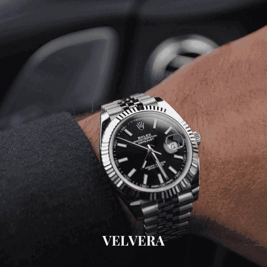 Luxury Rolex wristwatch with black dial and silver bracelet on man's wrist, Velvera brand