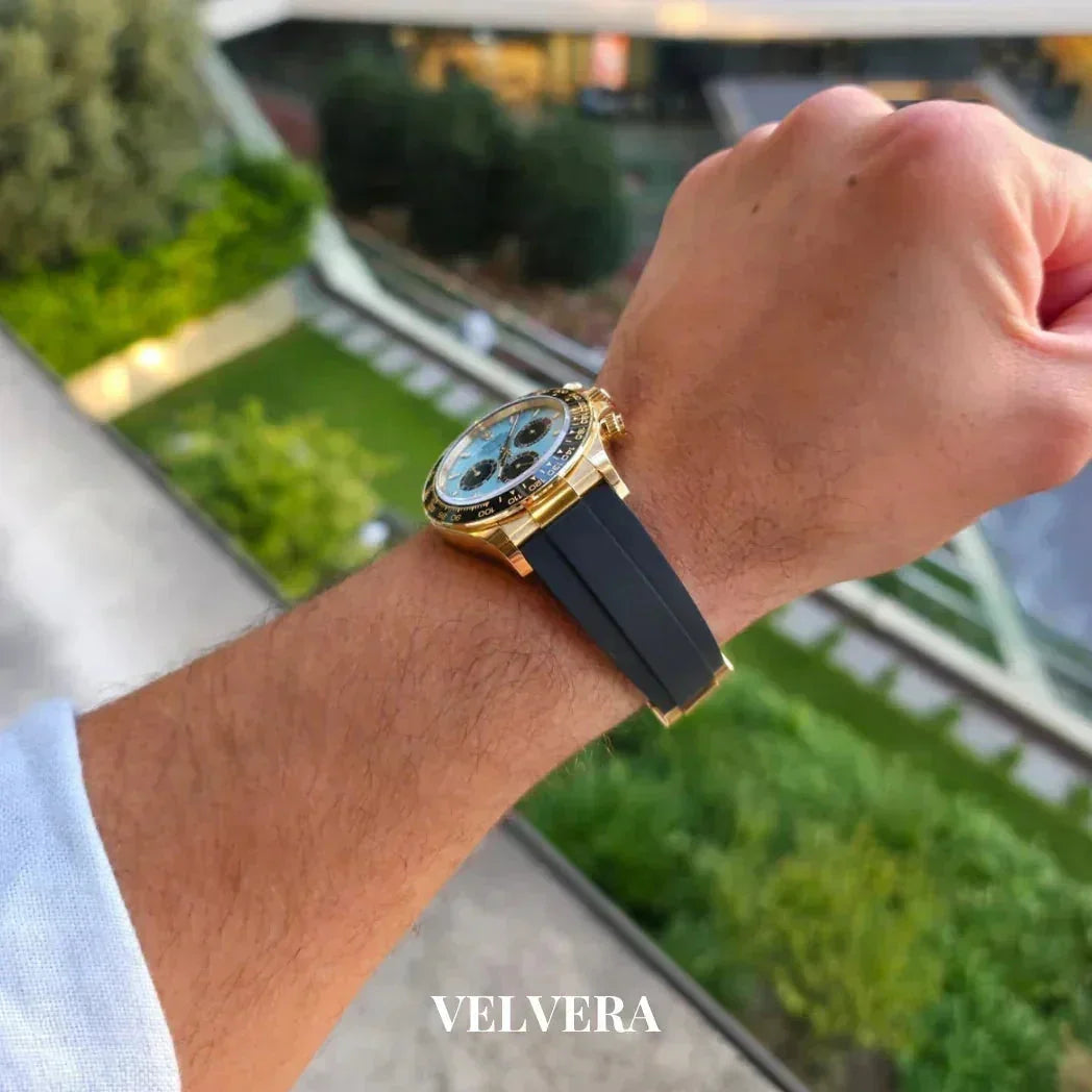 Gold luxury chronograph watch with black strap on wrist outdoors, VELVERA branding