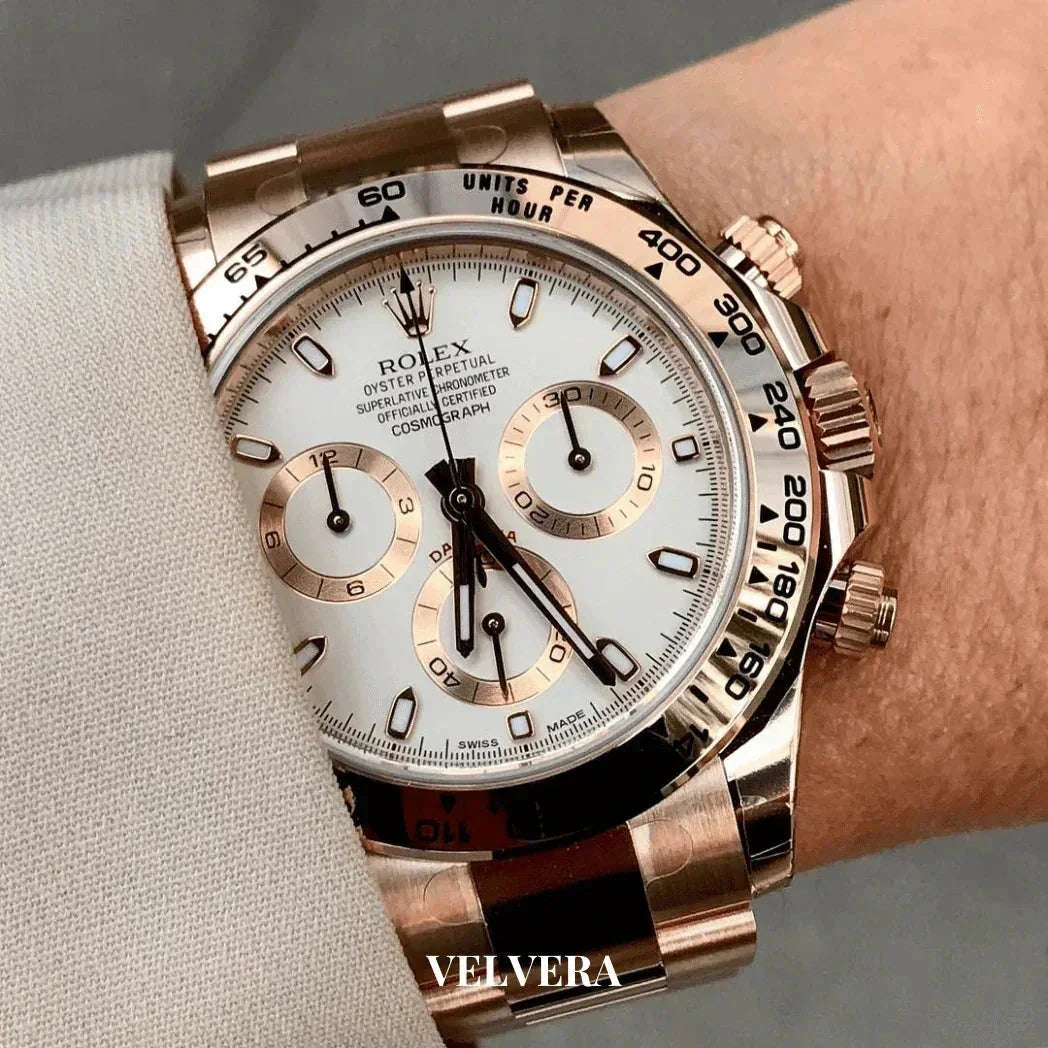 Rolex Daytona gold chronograph watch with white dial and rose gold bracelet on wrist