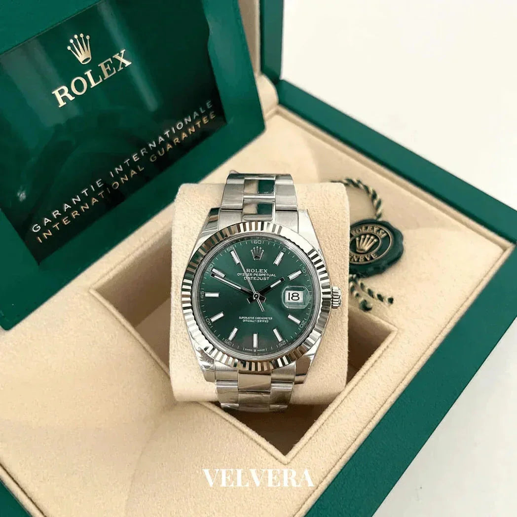Rolex Datejust green dial stainless steel watch in open green Rolex box, luxury timepiece