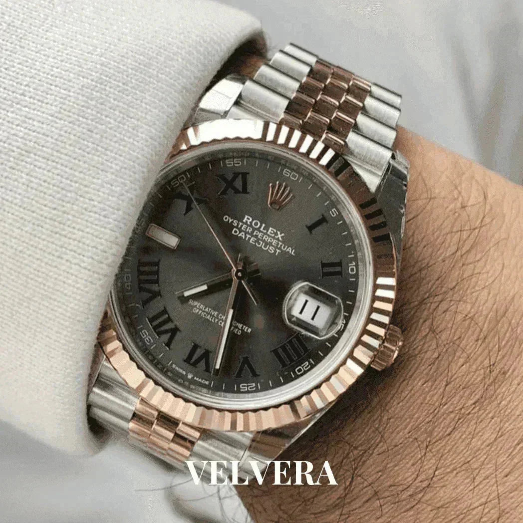 Rolex Datejust watch with two-tone metal strap and black Roman numeral dial on wrist