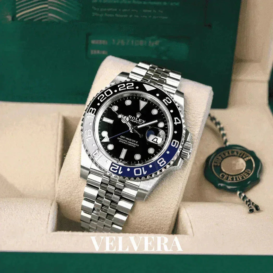 Rolex GMT-Master II watch with black and blue bezel on silver bracelet in green box