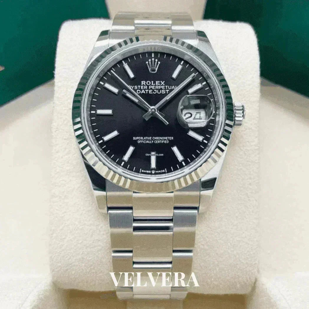 Rolex Datejust stainless steel watch with black dial on display, VELVERA branding visible