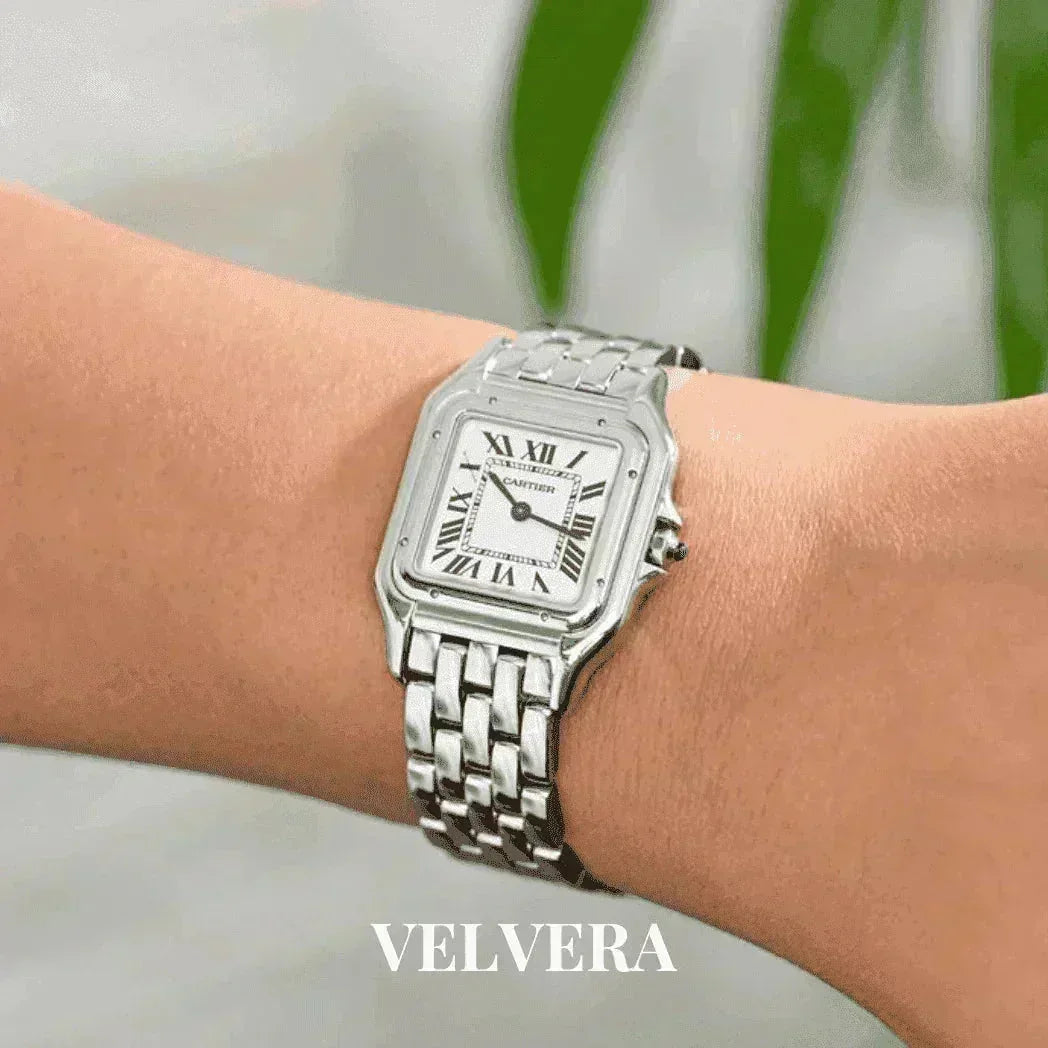 Women's silver Panthere style watch with Roman numerals on wrist, Velvera branding