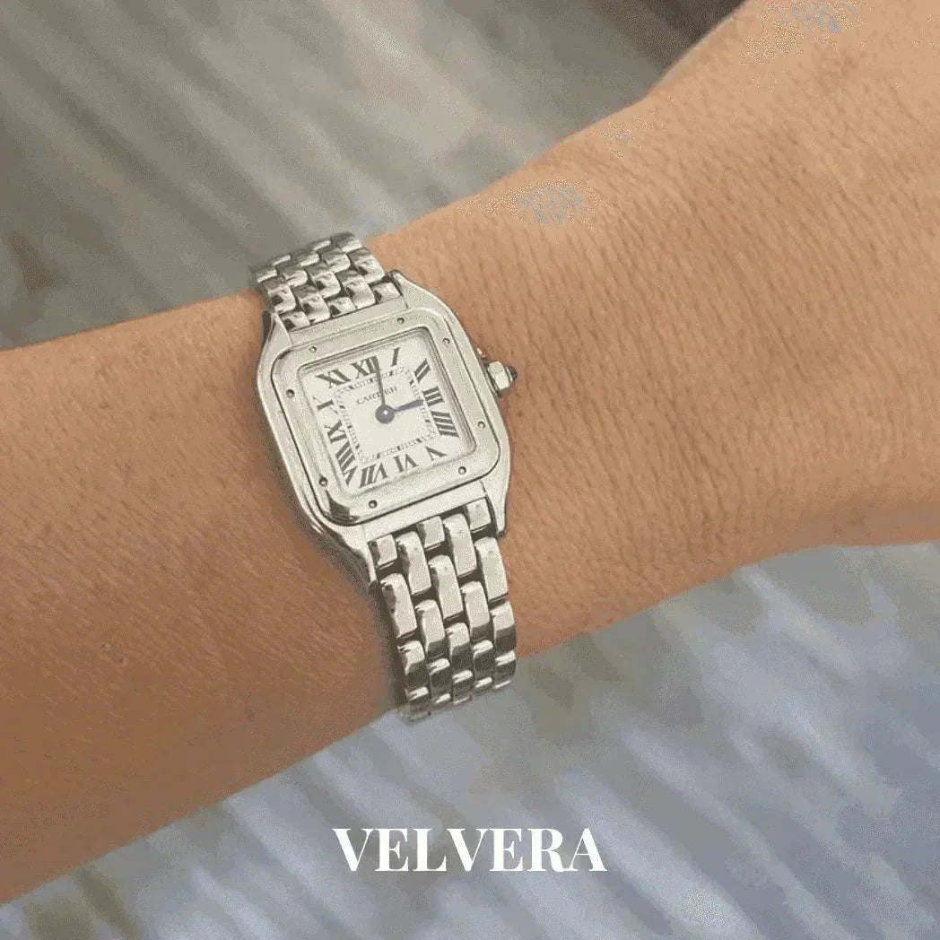 Silver women's Panthere watch with Roman numerals on wrist, Velvera branding visible.