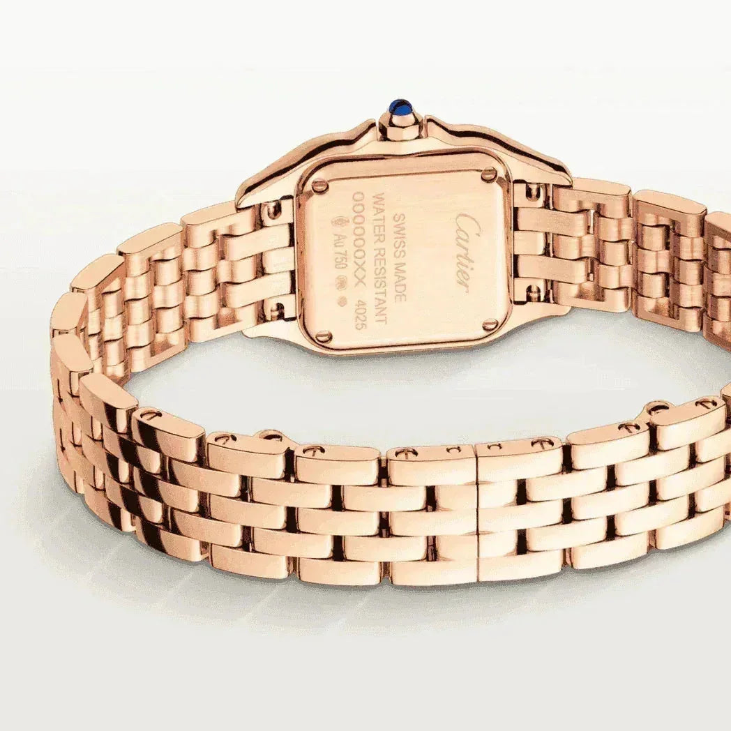 Rose gold women's watch with linked bracelet and engraved case back on white background