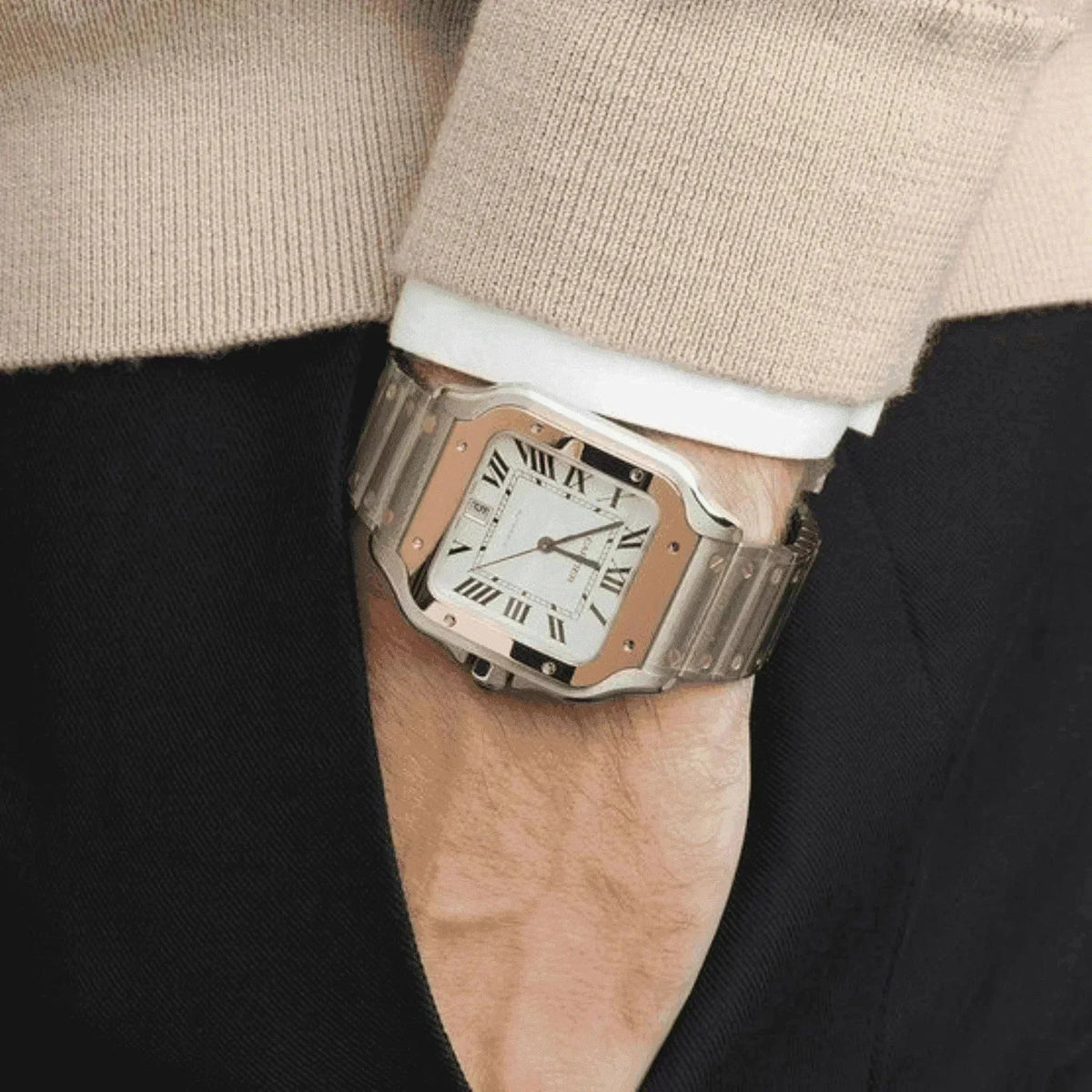 Luxury men's watch with silver metal bracelet and square face worn on wrist