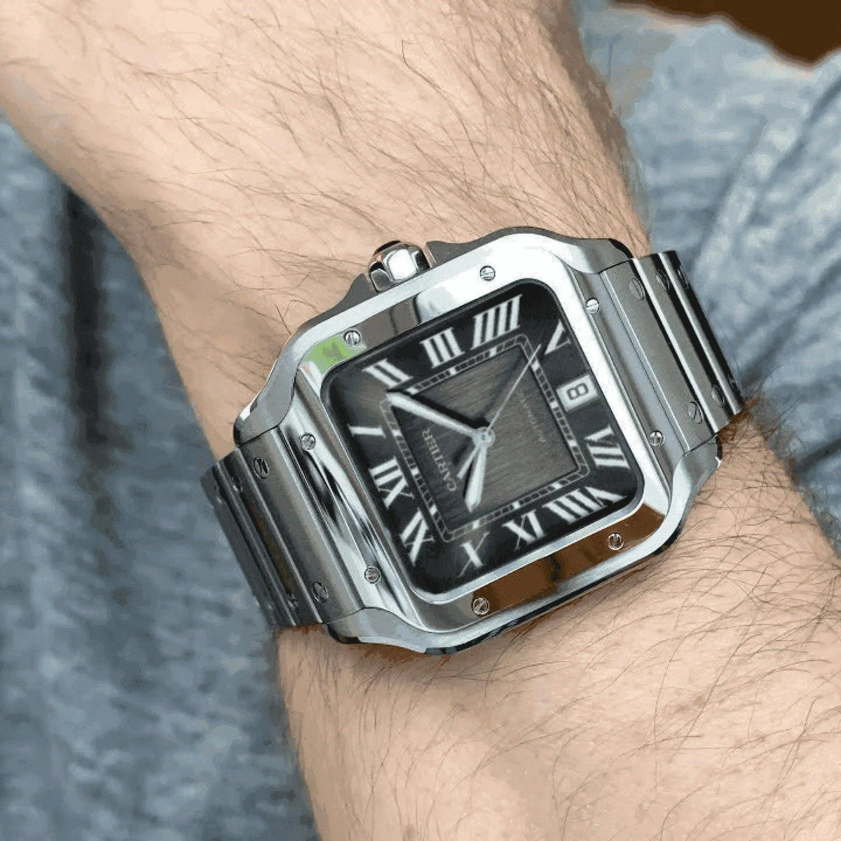 Men's Cartier Santos WSSA0037 stainless steel watch with black dial and Roman numerals on wrist