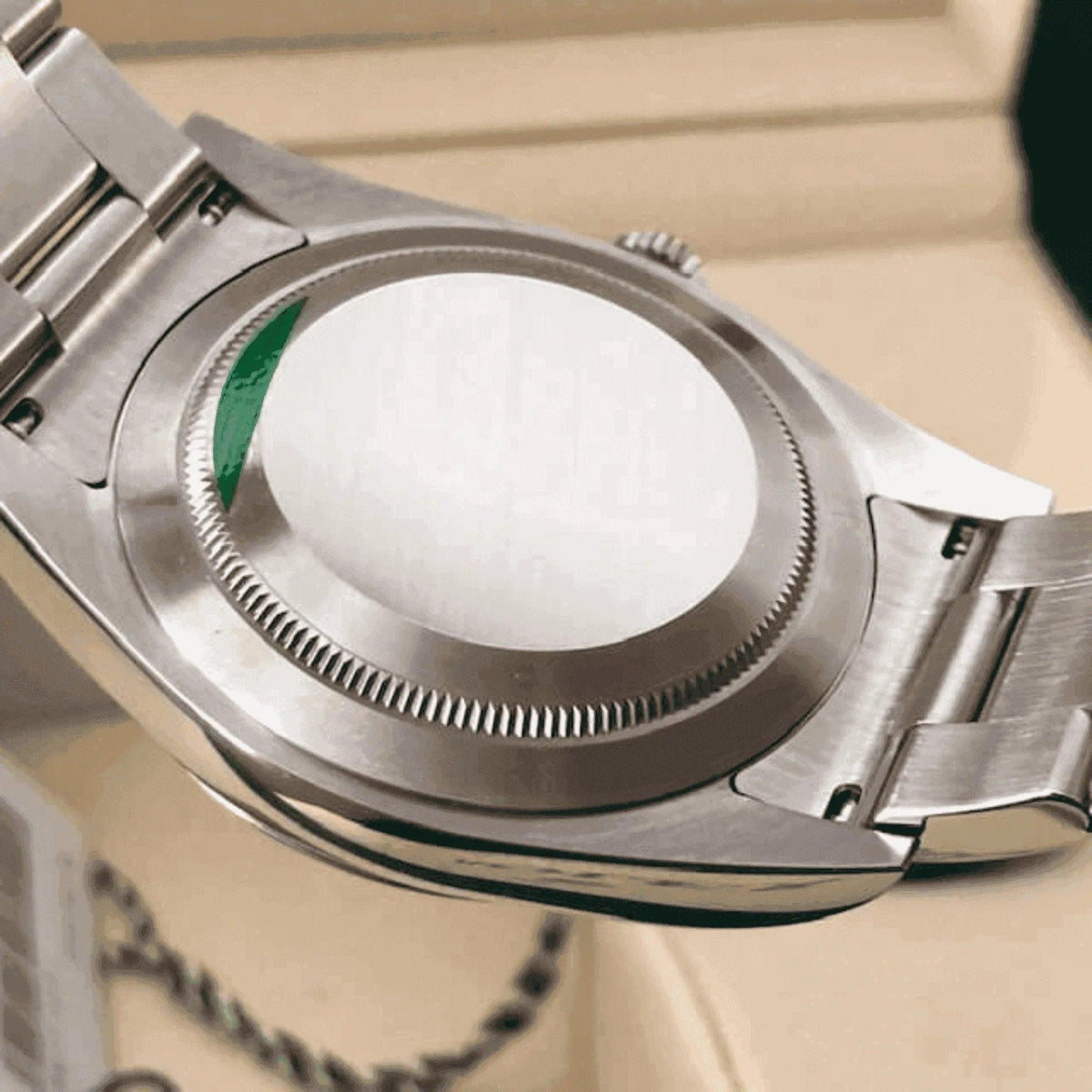Close-up of stainless steel men's watch case back and bracelet, classic design