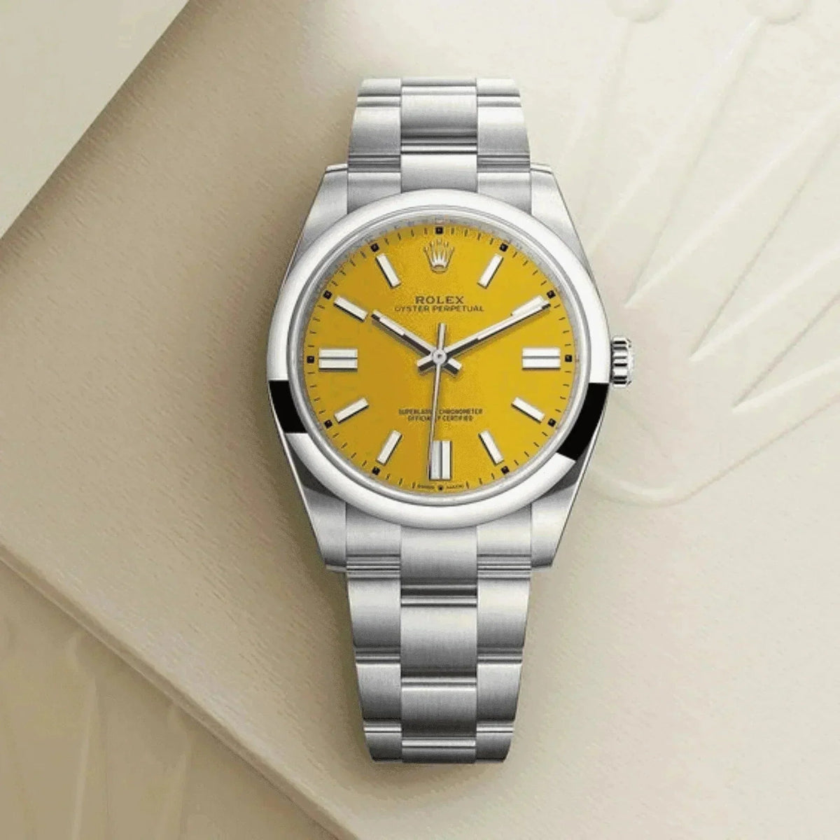 Men's classic stainless steel wristwatch with yellow dial on a light beige background