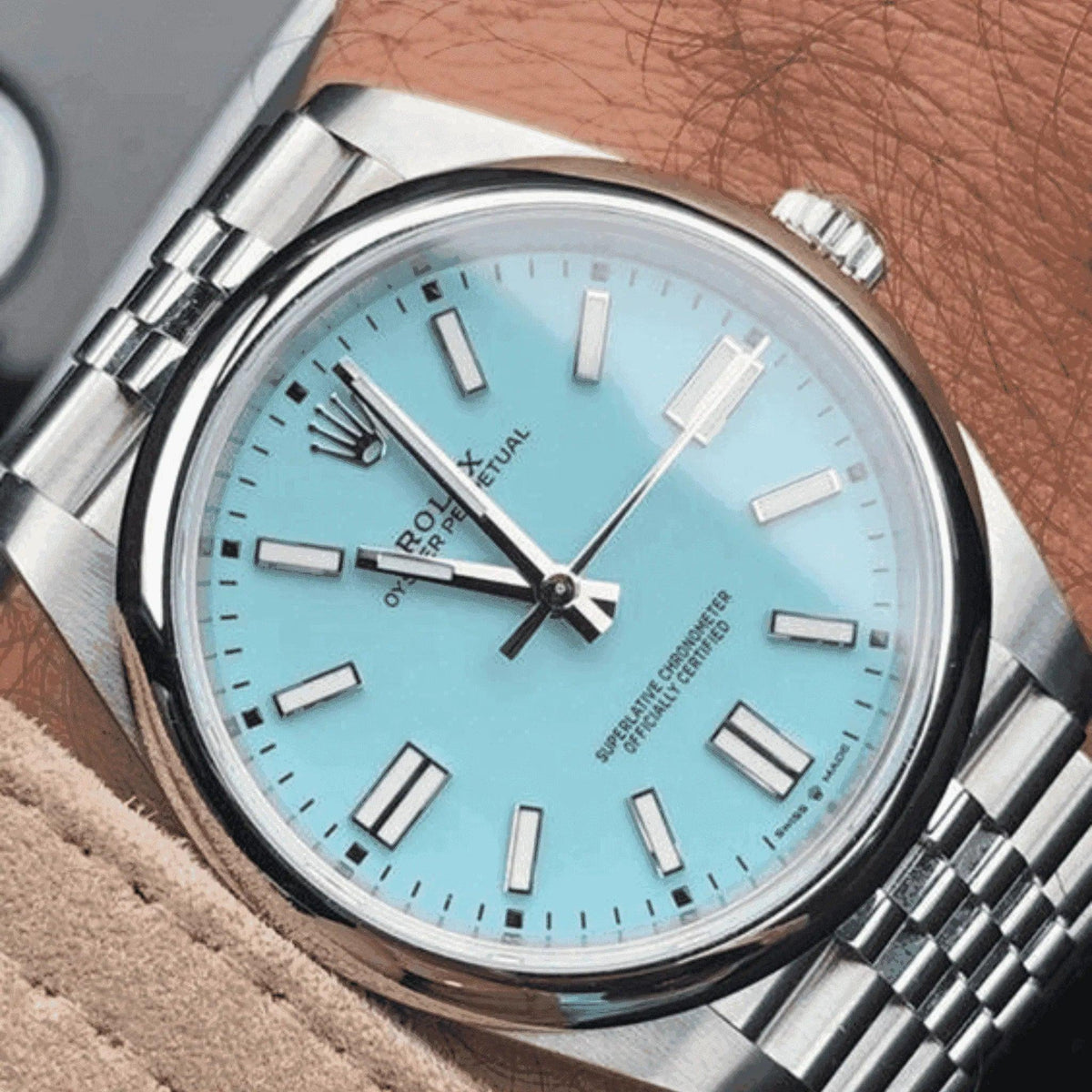 Classic men's wristwatch with light blue dial and silver bracelet on wrist