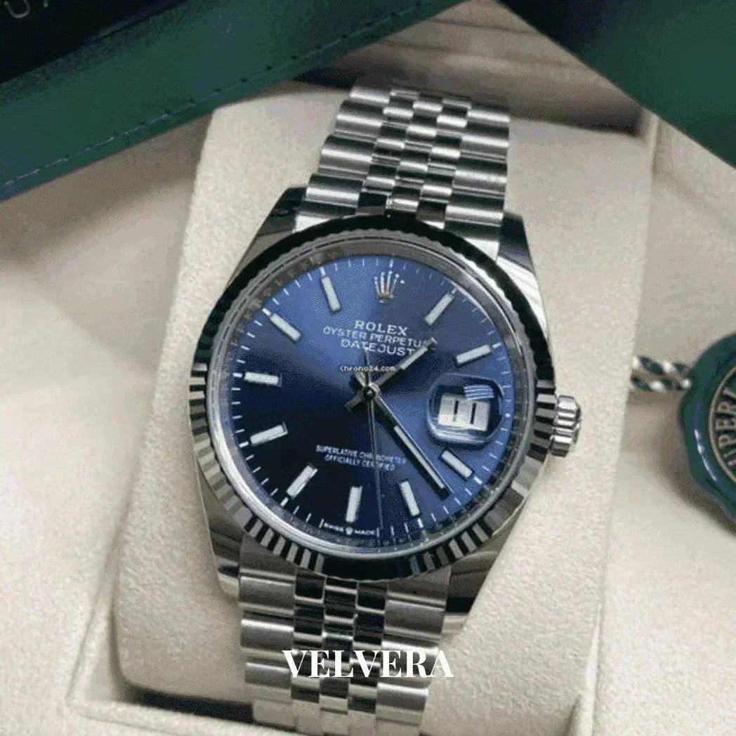 Blue dial Rolex Datejust 41 men's watch with silver bracelet on beige display, VELVERA branding