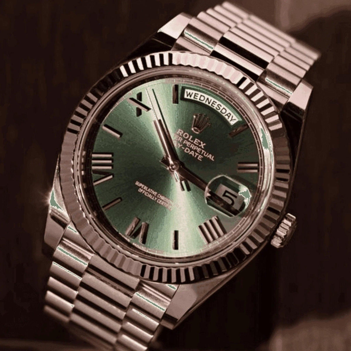Men's Rolex Day-Date Everose gold watch with green dial and Roman numerals on metal bracelet