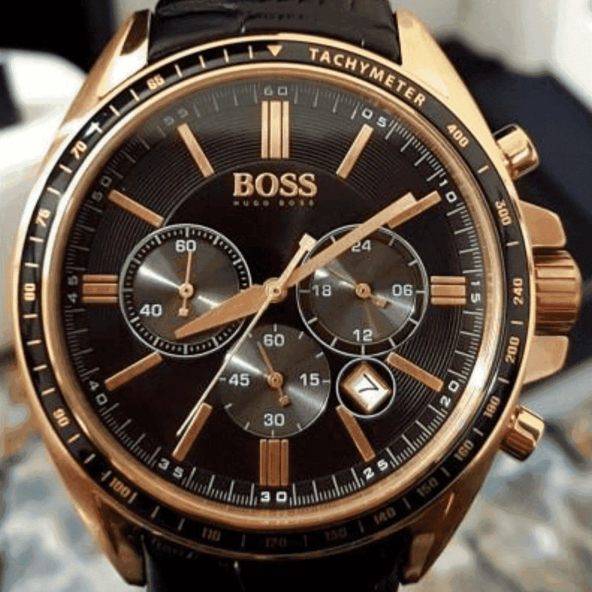 Hugo Boss men's gold chronograph watch with black dial, leather strap, and tachymeter bezel
