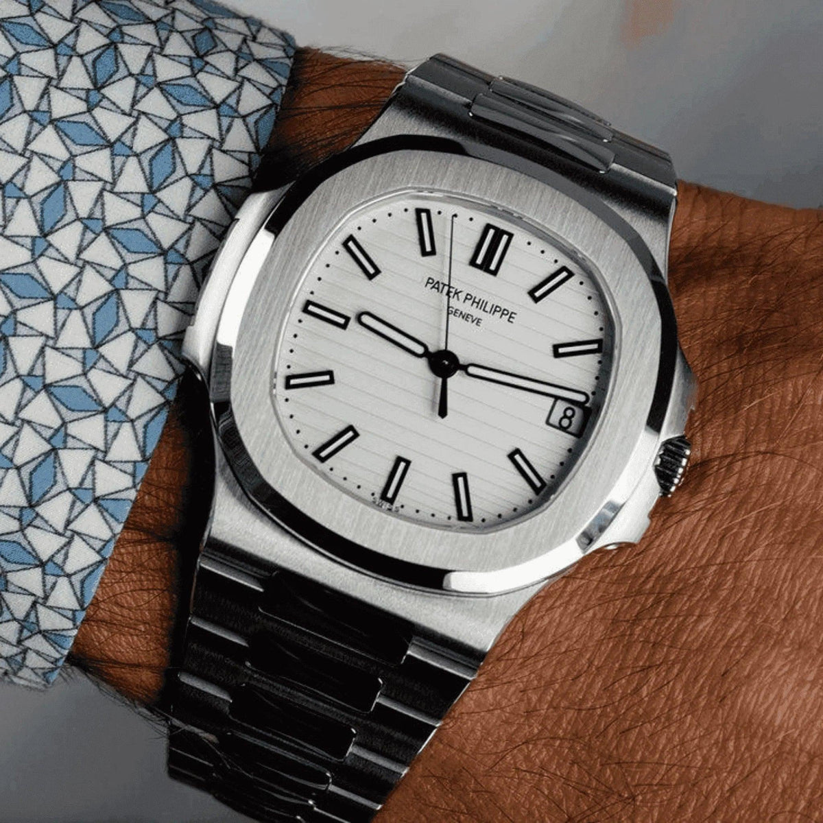 Patek Philippe Nautilus 5711/1A men's watch with white dial and steel bracelet on wrist