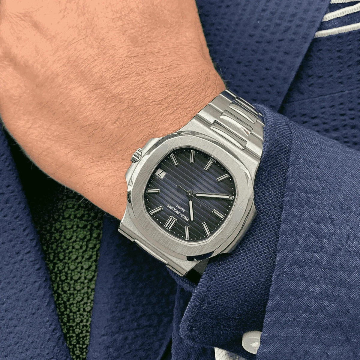 Men's Patek Philippe Nautilus 5711/1A silver automatic watch on wrist, blue suit jacket