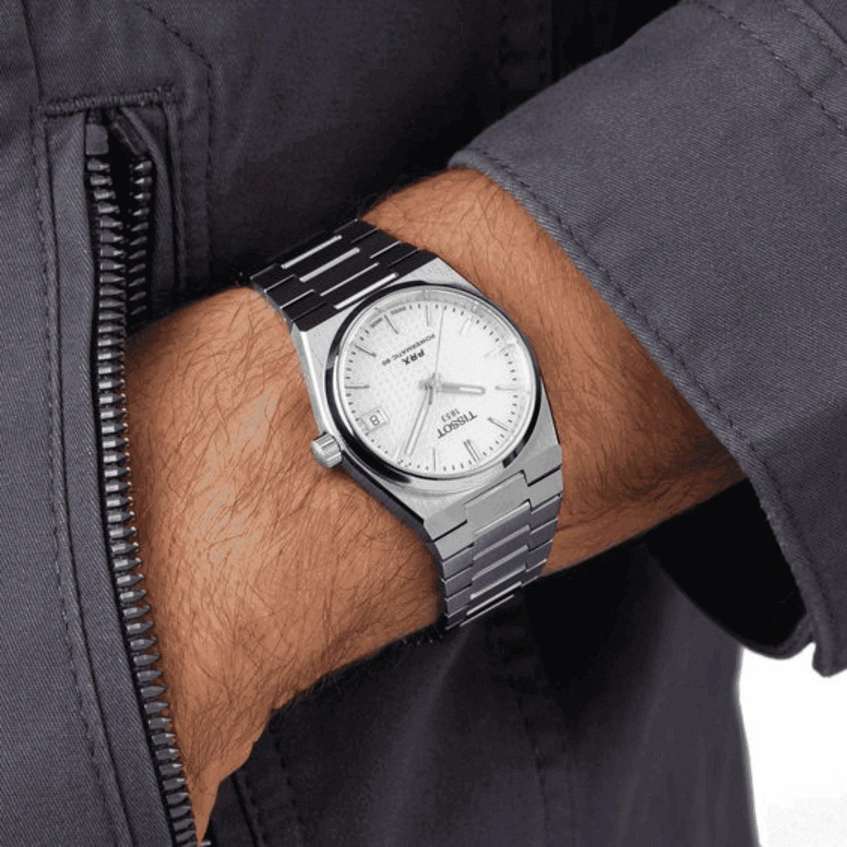 Men's Tissot Powermatic 80 silver stainless steel watch with white dial on wrist