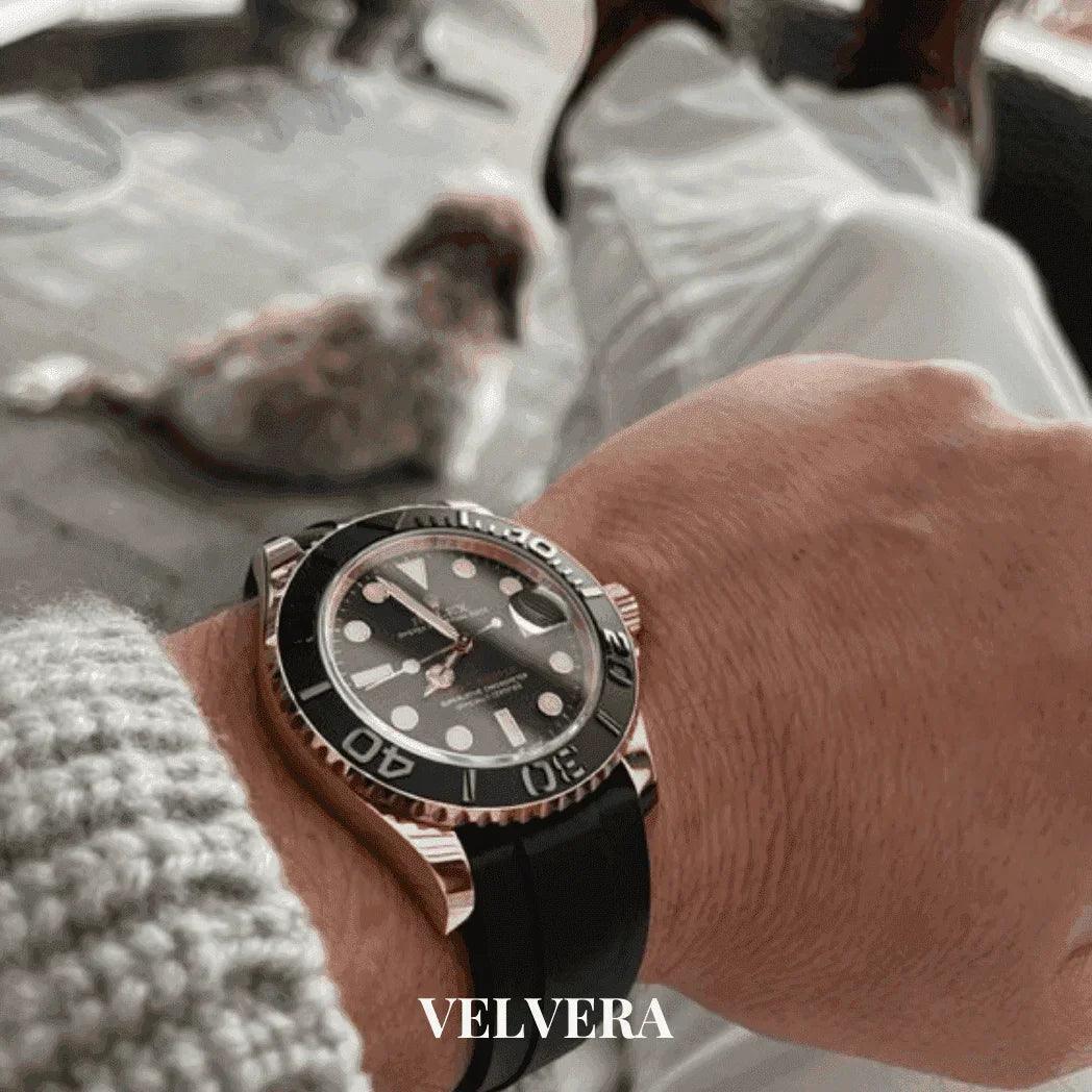 Yacht-Master watch with black dial and Oysterflex strap on wrist, Velvera branding visible